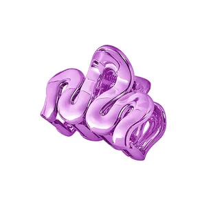 Detail view of wavy purple electroplated metal hair claw clip with a glossy finish