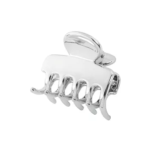 Macro detail of a hollow cloud-shaped silver metal hair claw with polished mirror finish