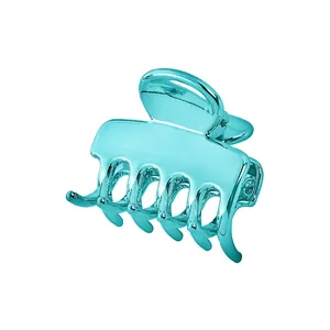 Detail of teal electroplated cloud-shaped hair claw clip with metallic hollow design