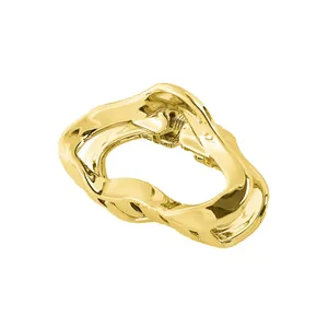 Detailed close-up of a polished gold cloud-shaped hollow metal hair claw clip with a glossy finish