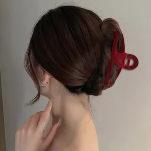 Elegant dark red flocked hair claw clip on model for a sleek ponytail hairstyle