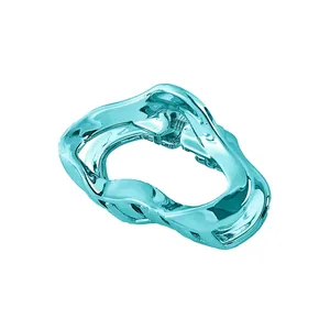 Detailed view of light blue wavy metal hair claw clip with a polished mirror finish