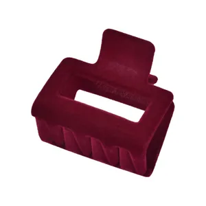 Detailed close-up of dark red flocked claw clip with matte texture and square cutout