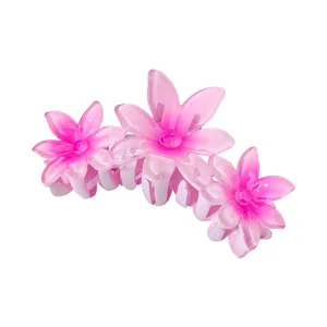 Detail of pink gradient resin flower hair claw clip with triple blossom design