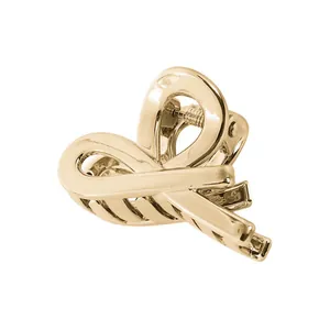 Detailed view of a gold hollow metal cloud hair claw clip with a strong spring mechanism