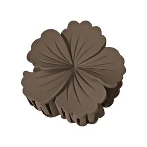 Detail view of large dark brown flower hair claw clip with matte petal texture