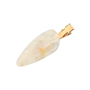 Detailed view of leaf-shaped acetate hair clip with France Handmade lettering
