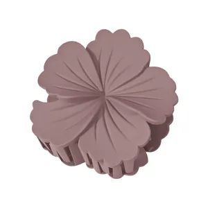Detail of matte frangipani flower hair claw clip in dusty rose with petal textures