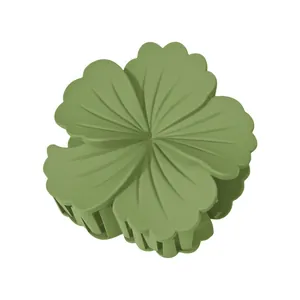 Macro view of a 8cm matte green flower hair claw clip with delicate radial textures