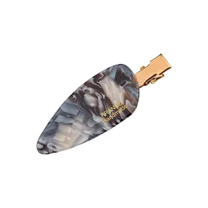 French style acetate hair clip with marble pattern and gold metal clasp on white background