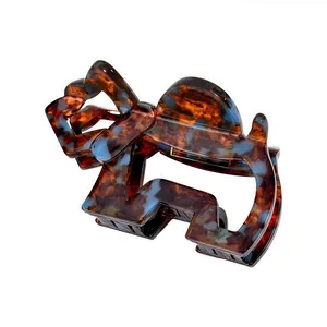 Tortoiseshell and blue marble acetate hair claw clip with geometric cutout design
