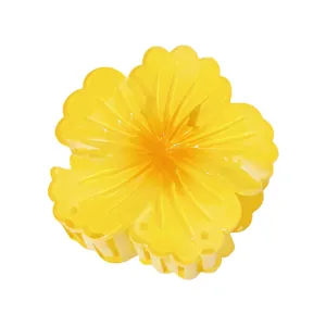 Detail of yellow flower hair claw with gradient resin petals and secure grip teeth
