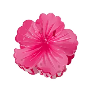 Detailed view of an 8cm bright pink frangipani hair claw clip with a glossy finish