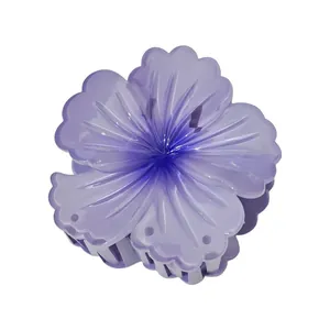 Detail view of purple five-petal plumeria hair claw clip with delicate radial textures