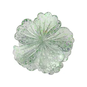 Detailed macro view of 8cm floral hair claw with green and purple gradient petal textures