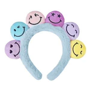 Kreativer Plüsch-Haarreif mit bunten Smiley-Bällen aus weichem hellblauem Material