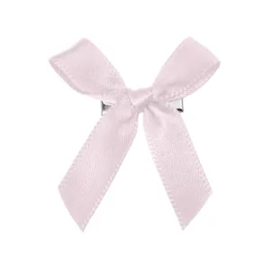 Détail de la pince à cheveux noeud en satin rose clair avec pince en métal argenté