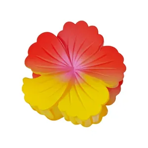 Close-up of 8cm gradient plumeria hair claw clip with vibrant red and yellow petals