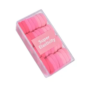 Close-up of 32pcs pink elastic hair ties set in a clear box with super elasticity label