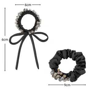 Set of black elastic hair ties with rhinestone bow and pleated satin scrunchie detail