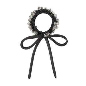 Elegant black scrunchie with crystal beads and long satin bow ribbon for hair