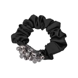 Detail of black satin scrunchie featuring faceted gray crystal beads and rich texture