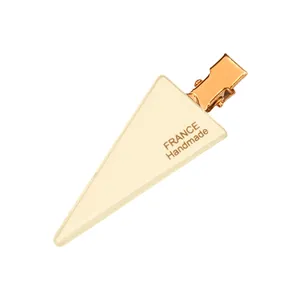 Minimalist cream acrylic triangle hair clip with gold metal grip and France handmade text