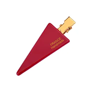 Red triangular acrylic hair clip with gold metal base and France Handmade text
