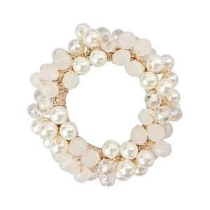 Macro shot of elastic hair tie featuring white faux pearls and faceted crystal beads