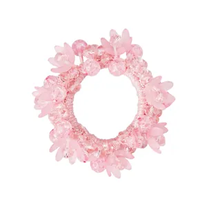 Detail eines rosa Kristall-Haargummis mit floralen Akzenten und hochelastischem Stoff