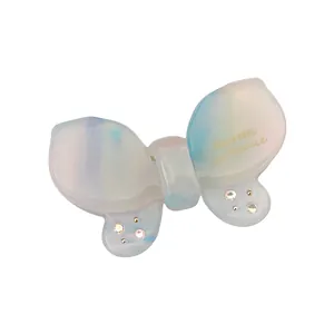 Macro view of butterfly hair clip with pearlescent resin finish and rhinestone details