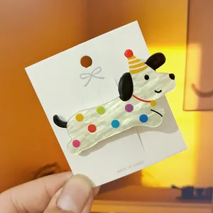 Cute acrylic dachshund dog hair clip with colorful polka dots and birthday hat on card
