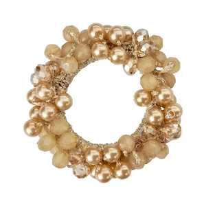 Close-up of champagne beaded hair tie with rhinestones and faux pearls for ponytail