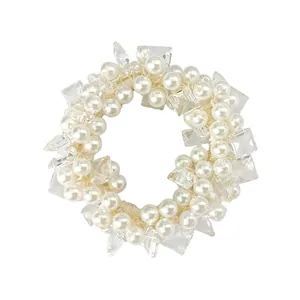 Detail of white faux pearl and crystal bead hair tie with elastic bow scrunchie design