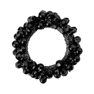 Close-up of black beaded elastic hair tie with faceted glossy crystal beads and pearls