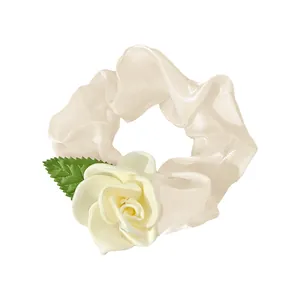 Elegant cream white camellia scrunchie with silk rose flower and green leaf detail