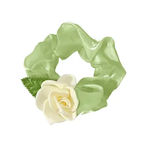 Elegant light green scrunchie with cream white camellia rose and leaf decoration