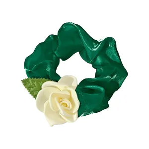 Elegant emerald green satin camellia scrunchie with white rose floral hair accessory