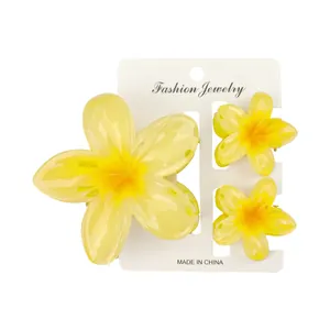 Detailliertes Set aus drei gelben Frangipani-Haarklammern auf weißer Displaykarte