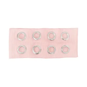 Pink ribbed sports headband with silver metal eyelets in a punk rock style for festivals