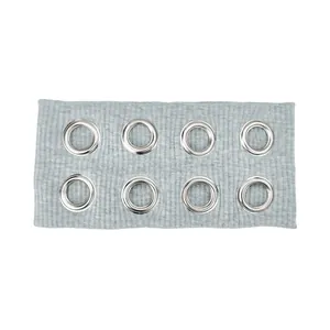 Close-up of light gray ribbed knit headband with eight silver metal eyelet grommets