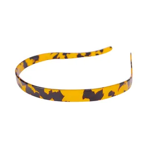 Detail of tortoise shell pattern headband in bright yellow and dark coffee resin finish