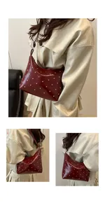 Detail shots of burgundy leather hobo bag with silver studs on a stylish trench coat