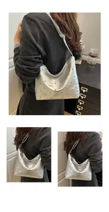 Close-up of silver metallic hobo bag featuring polished rivet studs and Y2K aesthetic