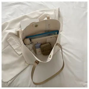 Top view of cream tote bag interior showing spacious capacity for tablet and daily items