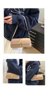 Detail view of beige lychee leather underarm bag with gold oval clasp and shoulder strap
