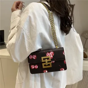 Fashionable brown crossbody bag with cherry prints and golden chain strap for women