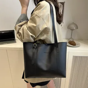 Chic black large capacity tote bag made of matte leather with gold buckle detail