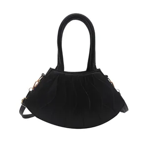 Minimalist black pleated shoulder bag with unique layered design and gold hooks