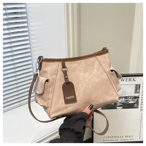 Detail of vintage beige canvas tote bag with brown trim and FASHION leather tag